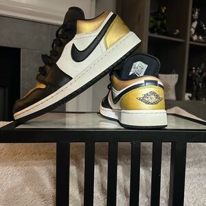 NIKE Air Jordan Black, Metallic Gold, and White leather Sneakers